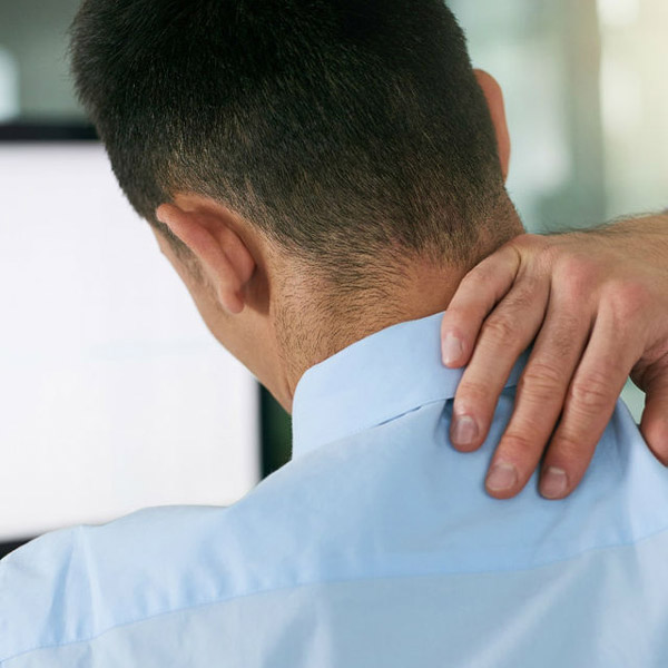 man holding neck in pain